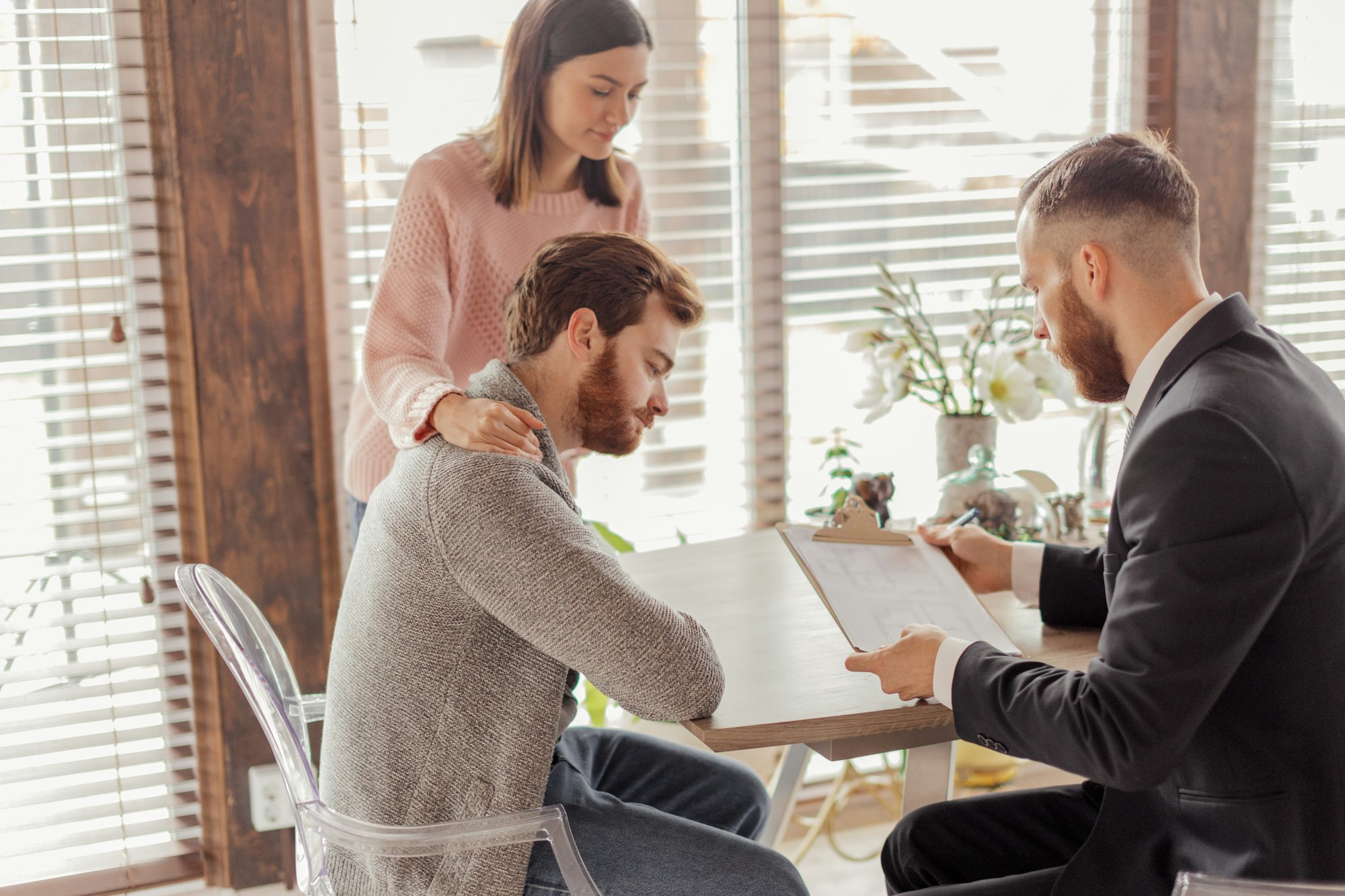 Family couple meeting with agent in office, buying, renting apartment or house.