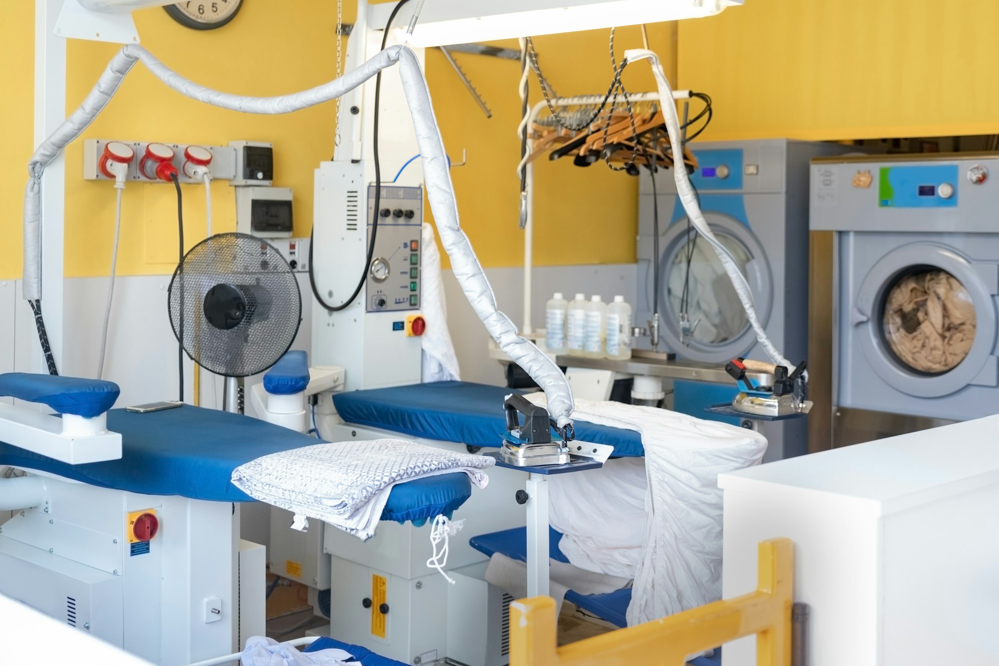 Laundry equipment. Professional Ironing table. Ironing. Dry cleaning servicing.